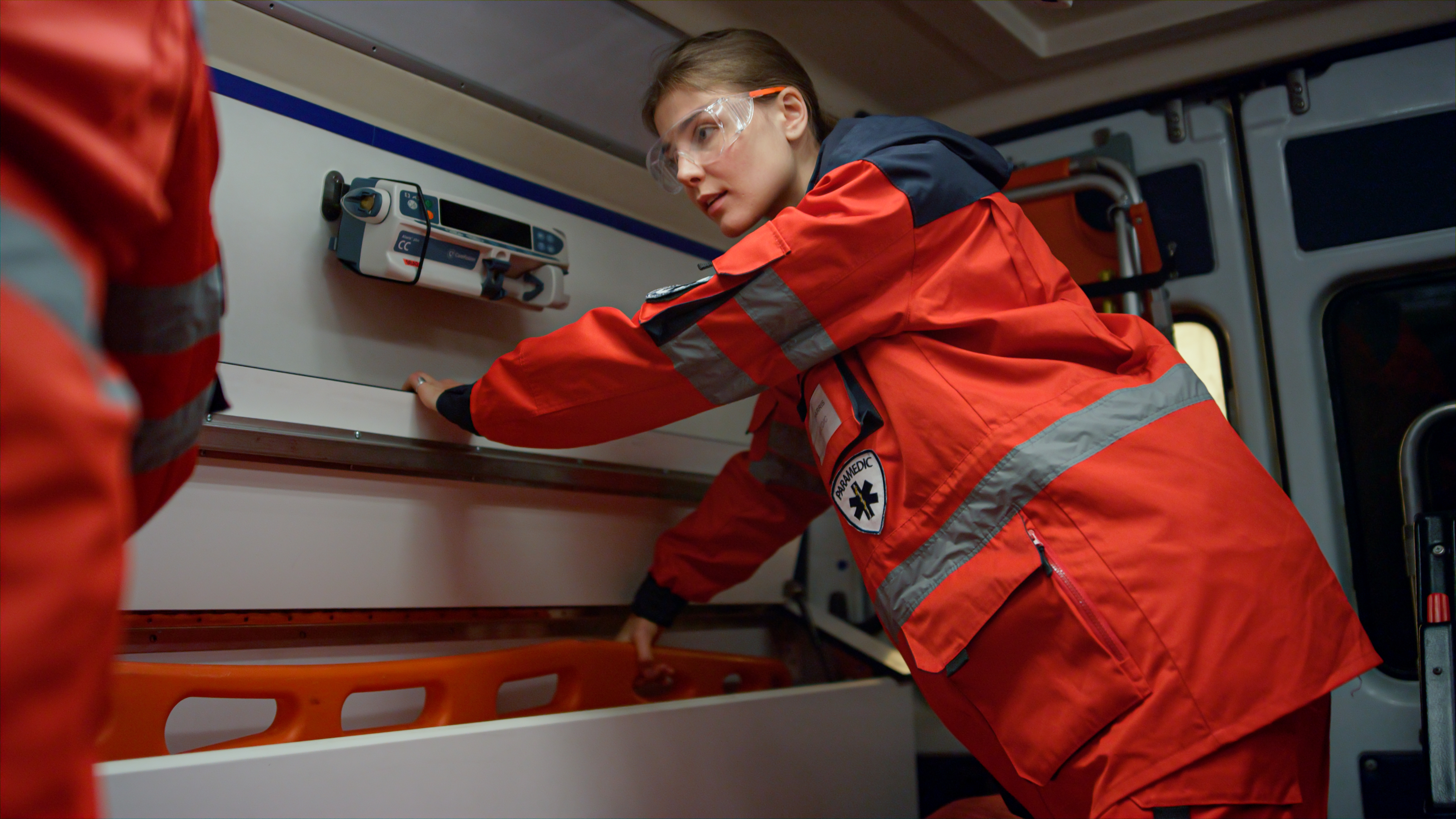 A paramedic attending to a patient inside an ambulance