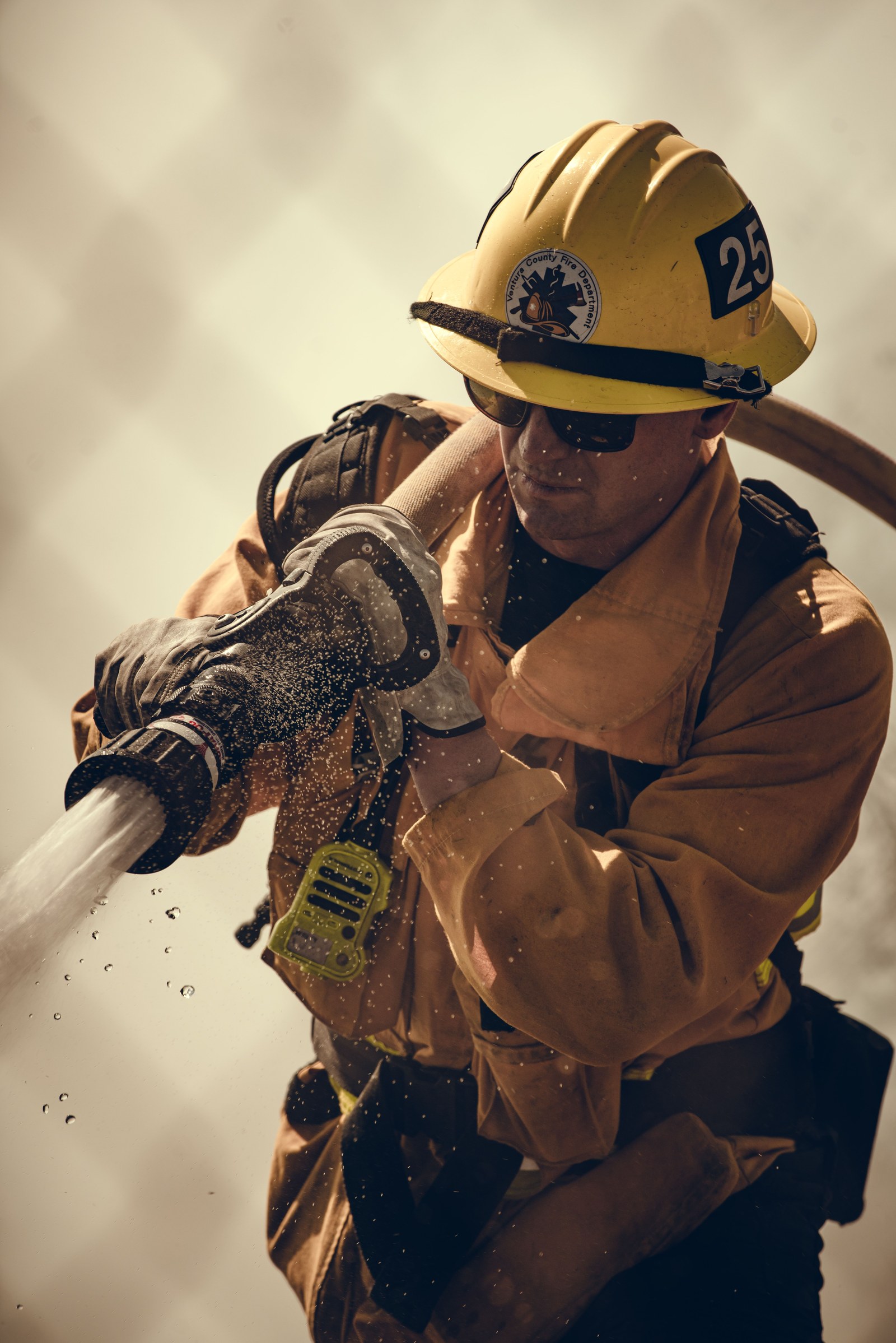 A firefighter in turnout gear at a station